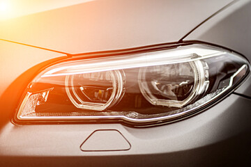 headlight front of modern prestigious car closeup