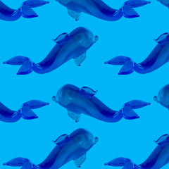 Summer seamless pattern with dolphins on a blue background.