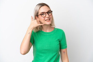 Young caucasian woman isolated on white background With glasses and doing phone gesture