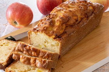 a cut apple cake on a wooden board