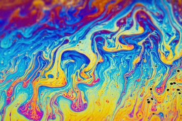 Fototapeta na wymiar Psychedelic abstraction, light interference on the surface of a soap bubble. iridescent rainbow on the surface of a soap bubble sphere