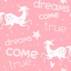 Seamless pattern with unicorns. Pink and white. Vector banner, apparel design, fabric print. Motivational poster with hand drawn lettering "Dreams come true". Trendy background with positive quote.