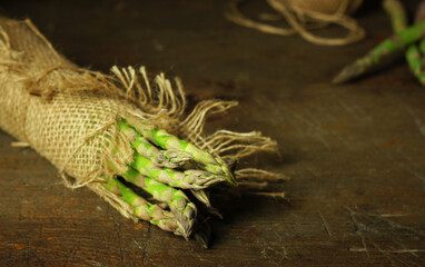 Green fresh asparagus on a wooden table