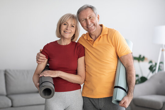 Portrait of mature couple having workout at home