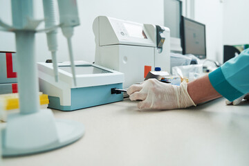 Woman researching blood tests with modern equipment