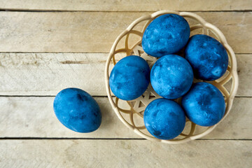 Blue painted eggs on a wooden background