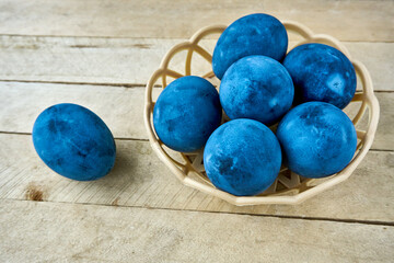 Blue painted eggs on a wooden background