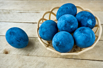 Blue painted eggs on a wooden background