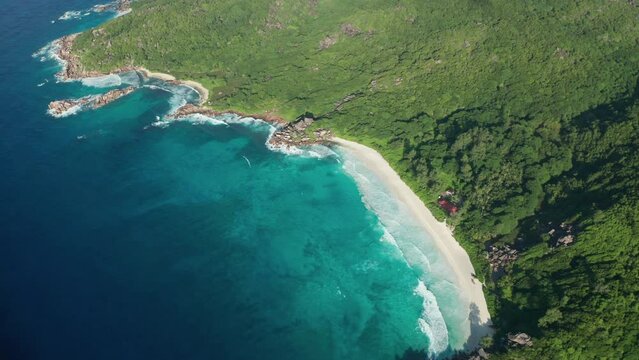 Aerial dolly tilt up over southern part La Digue in Grand Anse beach