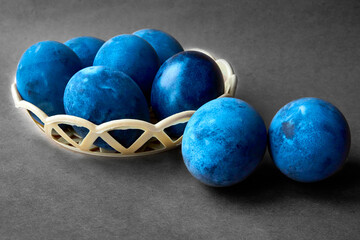 Blue painted eggs on a gray paper background