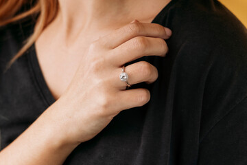 Close up of a blurred ring on woman's finger.Wedding and love concept.