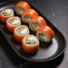 Philadelphia sushi roll with salmon, cucumber, avocado, cream cheese. Sushi menu. Japanese food