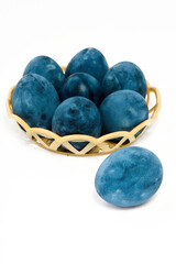 Blue painted eggs on a white background, vertical shot