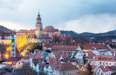 Fototapeta premium Beautiful view to Cesky Krumlov castle and its tower in Czech republic at sunset with dramatic clouds. Horizontally.