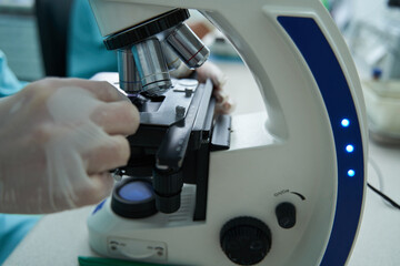 Woman is using microscope in medical laboratory