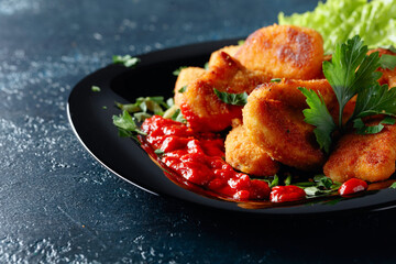  Fried chicken nuggets with ketchup, sprinkled with chopped parsley.