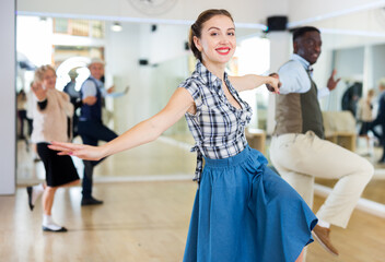 Woman and man dancing swing in studio