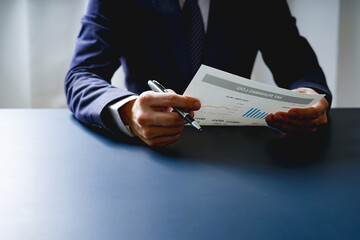 Businessman doing finances and calculate about cost to investment , business Financing Accounting Banking Concept, tax system