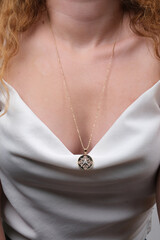 Close-up young woman wearing gold chain necklace. Modern fashion details. minimalist lifestyle