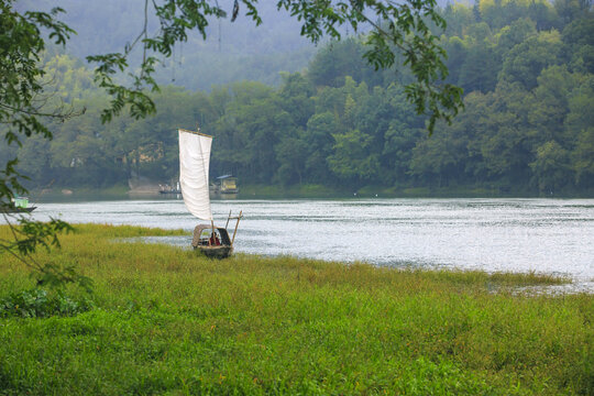 a white sailing boat on the river, Spring Scenery of Songyang ancient village in Lishui, Zhejiang Province