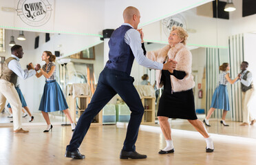 Two professional dancers practicing lindy hop in dance class