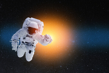 Astronaut in outer space. National Astronaut Day is an American commemorative day. Elements of this image furnished by NASA.