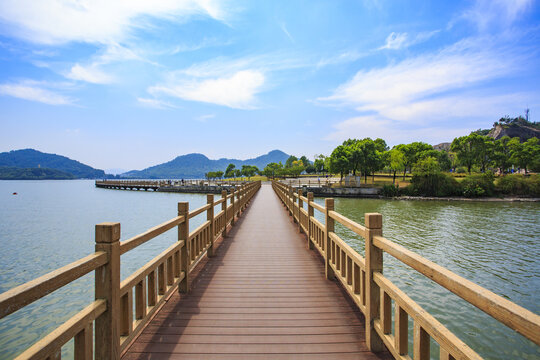 a bridge on Dongqian lake under blue sky