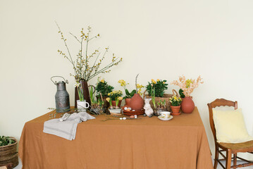 Serving of the Easter holiday table with primroses, eggs and rabbits in natural color