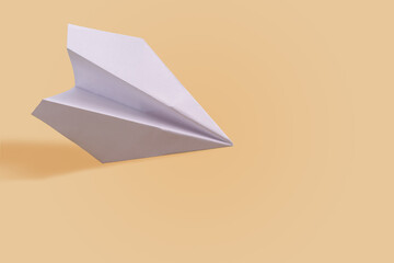 Paper airplane on a tone-harmonious background, toned