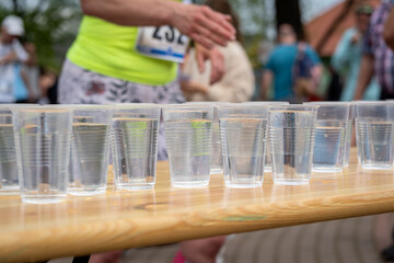 plastic pet cups filled with water for runners after running race