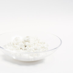 cottage cheese in a glass transparent bowl isolated on a white background
