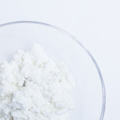 Fototapeta na wymiar cottage cheese in a glass transparent bowl isolated on a white background