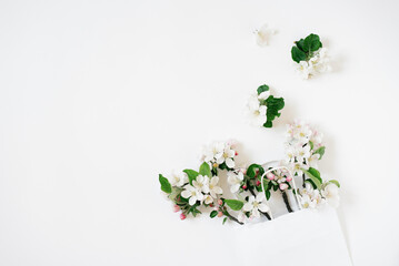 Sell concept. White shopping bag on white background decorated with spring flowers apple tree with copy space