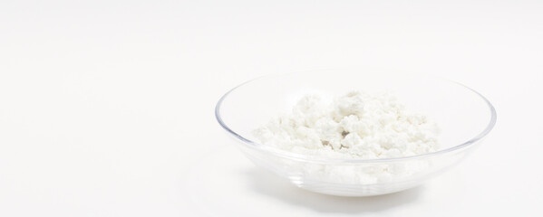 cottage cheese in a glass transparent bowl isolated on a white background
