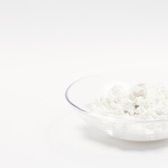 cottage cheese in a glass transparent bowl isolated on a white background