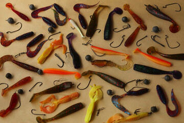 Flatlay of soft silicon colorful freshwater fishing baits, hooks and lures