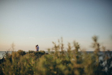 couple walking  in the field among the hills