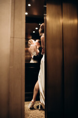 newlyweds hugging in an elevator