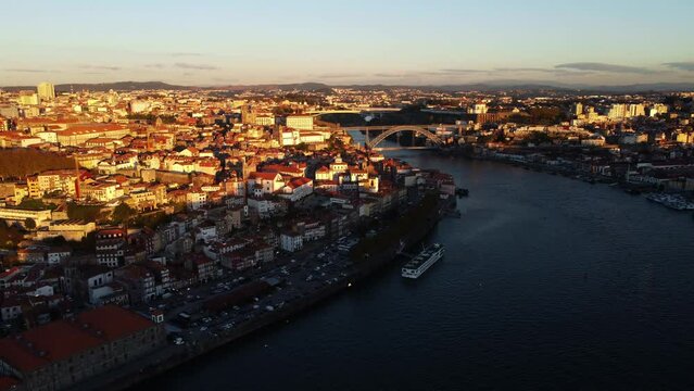 Drone view of the sunny bank of the Duero river with houses.