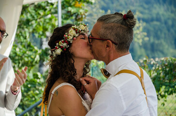 bride and groom kissing in park