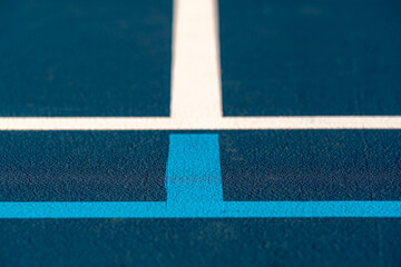Fototapeta na wymiar Blue tennis court with white lines and light blue pickleball lines