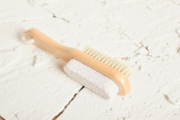 wooden natural massage brush, pedicure brush on concrete cracked background