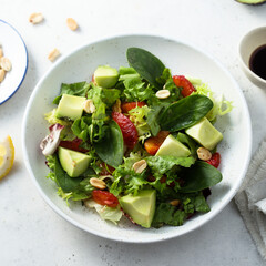 Healthy green salad with avocado and bloody orange