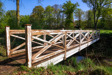 Fototapeta na wymiar Historische Holzbrücke in einem Schlosspark in Rheda-Wiedenbrück
