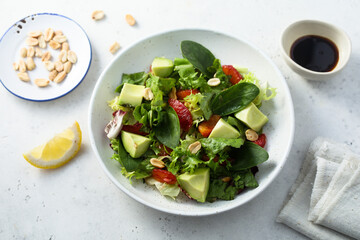 Healthy green salad with avocado and bloody orange