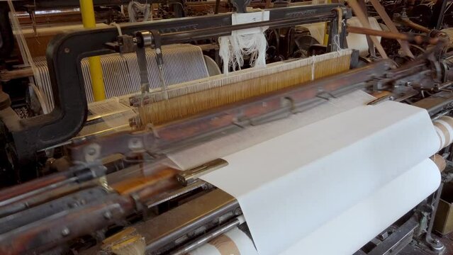 A cotton loom at a working textile mill, with audio. Seamless loop