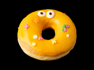 Donut with yellow icing and confetti with eyes