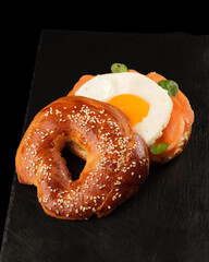 bagel with salmon, egg and basil.