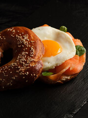 bagel with salmon, egg and basil.