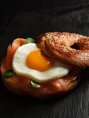 bagel with salmon, egg and basil.